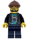 Race Truck Driver - Male, Black Jacket over Dark Turquoise Shirt with Hawk Head Logo, Dark Blue Legs, Reddish Brown Flat Cap, Beard, Glasses